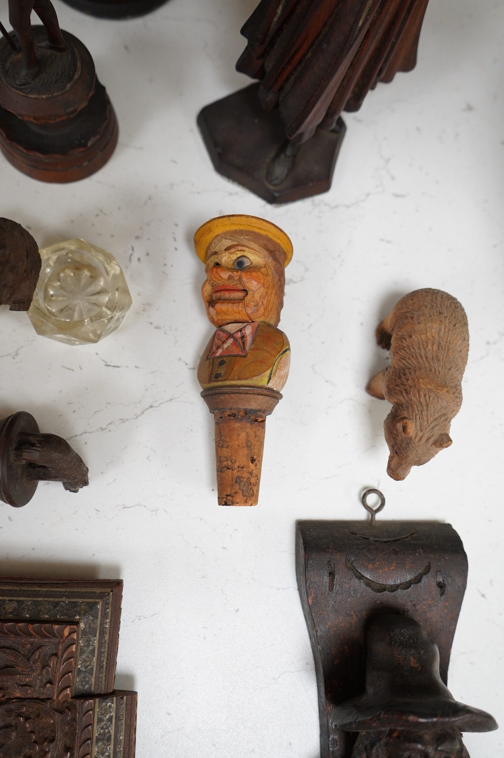 A collection of Black Forest wooden figurative carvings to include a pair of corbels in the form of musicians and a carved bear bottle stopper, largest 32cm high. Condition - mostly fair